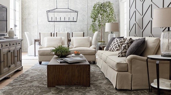 luxury living room featuring off white sofa and chairs, grey area rug and wooden table and tv stand
