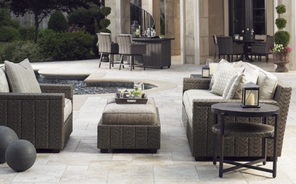 luxury patio including brown outdoor furniture including sofa, chair and small table