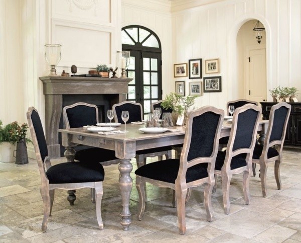 luxury dining room with large wooden table and eight black and wood chairs