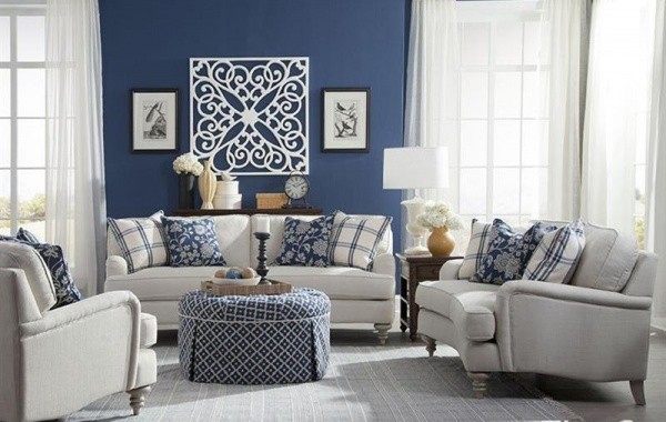 luxury living room featuring blue and white color scheme with white sofas and chairs, and a blue and white patterned circular table