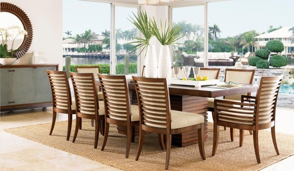 luxury dining room with brown wood table with ten wooden chairs with tan seats and backs