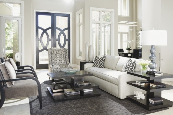 luxury living room featuring white and grey color scheme with white sofa, grey chairs and black furniture