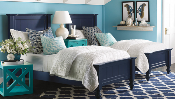 luxury finished interior bedroom with blue, white and cyan color scheme with two beds and cyan wooden nightstands