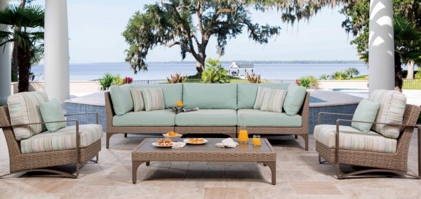 luxury patio with cyan colored sofa, multicolored wicker chairs and wicker table
