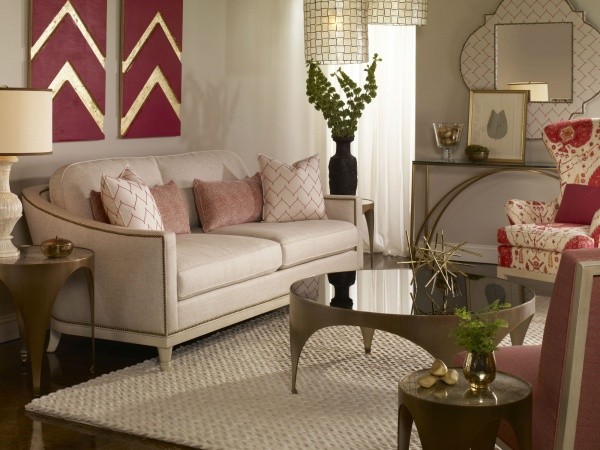 luxury living room featuring off white and red colors with off white sofa with pink pillows and red and white chairs with round table