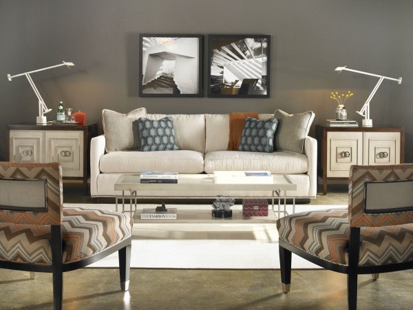 luxury living room featuring white sofa with pillows, white rug, metal table and brown multicolor chairs