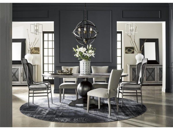 luxury dining room with round grey table and six grey chairs
