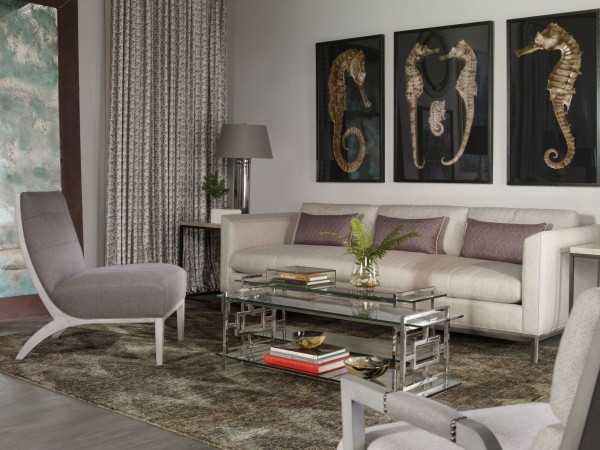 luxury living room featuring grey furniture and seahorse paintings
