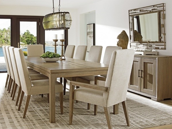 luxury dining room with light brown table featuring ten eggshell and wood chairs