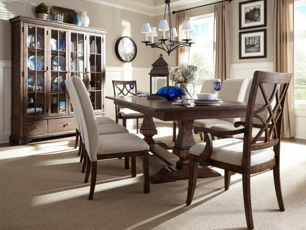 luxury dining room with wooden table and eight cream and brown chairs with blue crystal accents