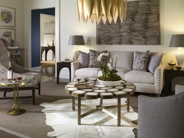 luxury living room featuring grey color scheme with grey sofa and grey patterned chairs with round cobblestone table