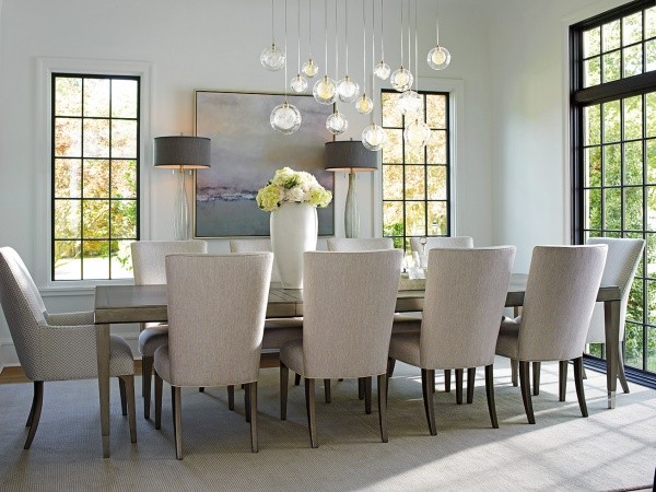 luxury dining room with wooden dining room table with ten white and wood chairs
