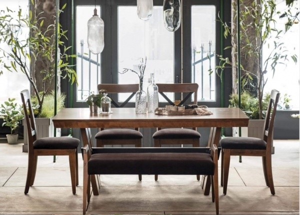 luxury dining room with wooden rectangular table, 4 black and wood chairs, and a black and wood bench