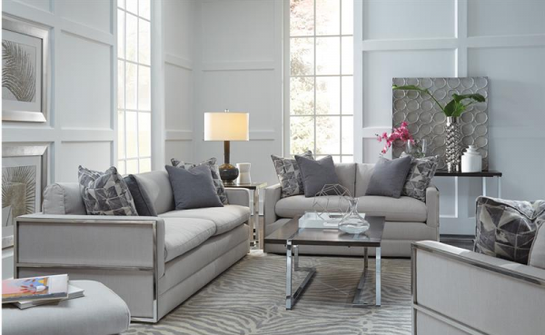 luxury living room featuring grey sofas with silver accents with grey animal print rug