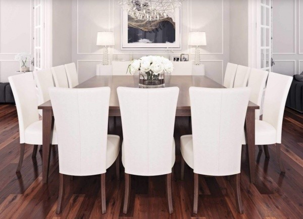 luxury dining room featuring 14 person dining room table with white chairs with brown wood legs
