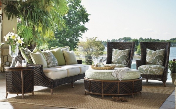 luxury patio including with brown, white and olive color scheme including sofa, two chairs and round table