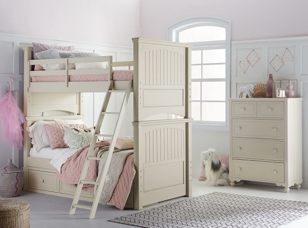 luxury finished interior bedroom with cream colored bunk beds with cream furniture and white and pink bedding