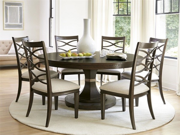 luxury dining room with brown round table with six wooden chairs with cream seats