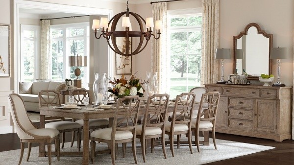 luxury dining room with wood table and ten wooden chairs with cream seats