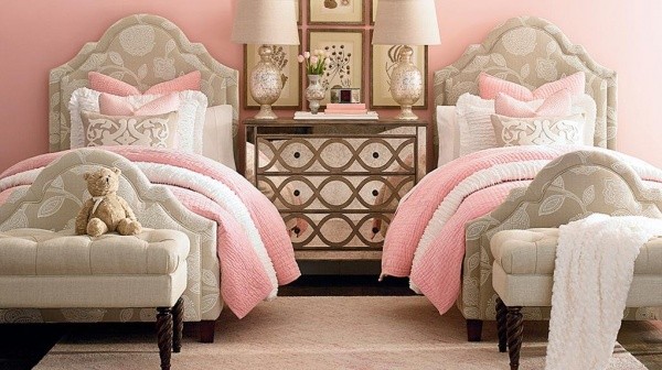 luxury finished interior bedroom with two beds with tan, white and pink color scheme with tan ottomans and brown wood nightstand