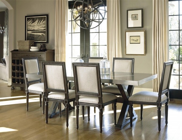 luxury dining room with grey and black table with six grey and black chairs on hardwood floor