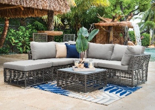 luxury patio including grey wraparound sofa and square table on blue and white floral rug
