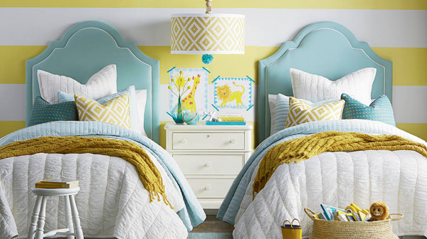 luxury finished interior secondary suite with two beds with cyan, white and yellow color scheme with white wood furniture