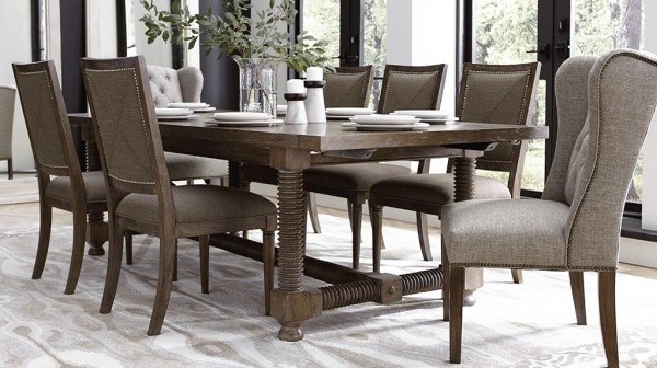luxury dining room with brown wooden table and six grey and brown chairs