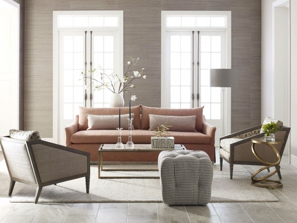 luxury living room featuring light red sofa, grey chairs and white area rug