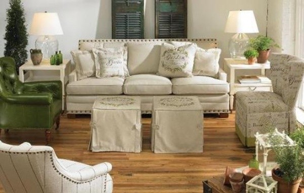 luxury living room featuring white and green color scheme with white sofa, and green chairs