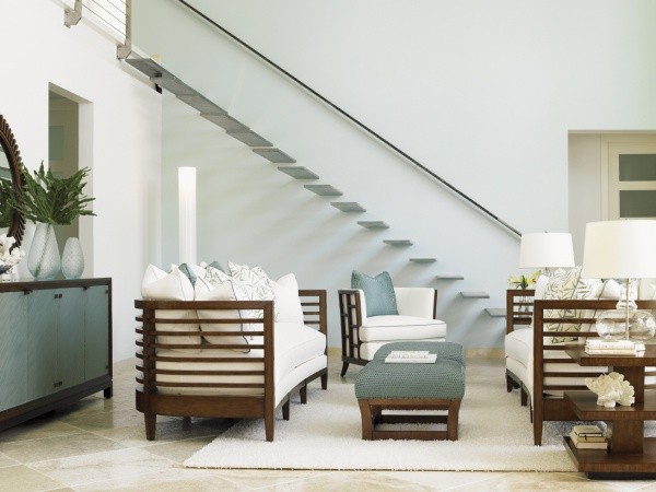 luxury living room featuring cyan and white color scheme with white and wood sofas with cyan table and white rug