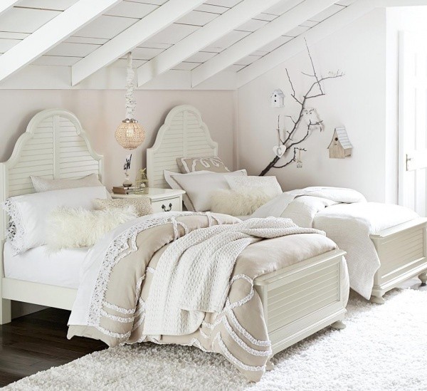 luxury finished interior bedroom with white and cream color scheme with two white wood beds and white shag rug and white nightstand