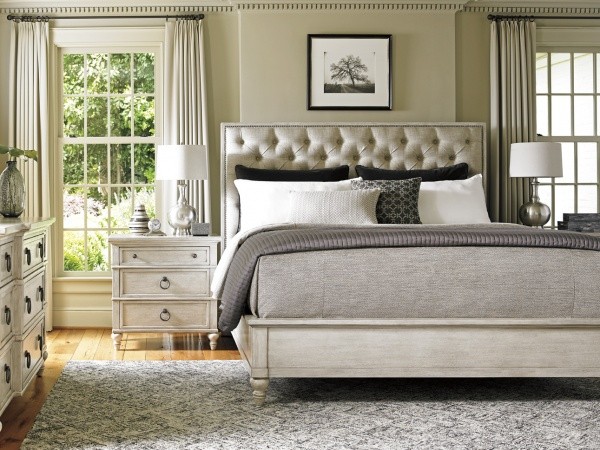luxury home furniture master bedroom with grey bed, and white wooden nightstands and dresser