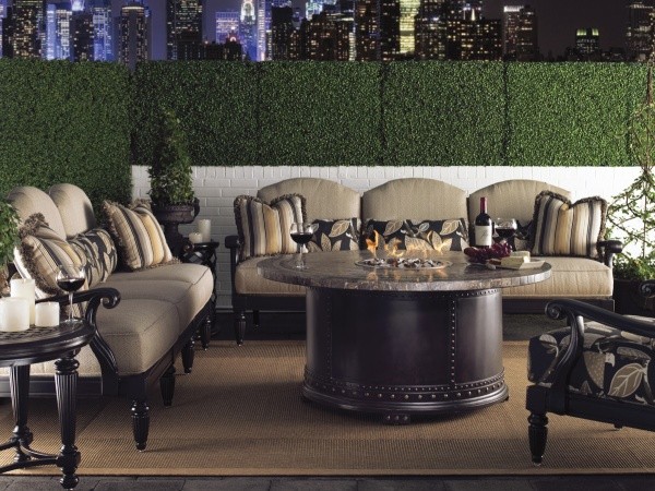 luxury patio including brown and black sofas and chairs with round black and brown table with brown area rug
