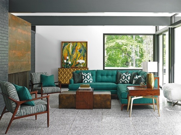 luxury living room featuring green wraparound sofa with two green and whit chairs with modern wood furniture