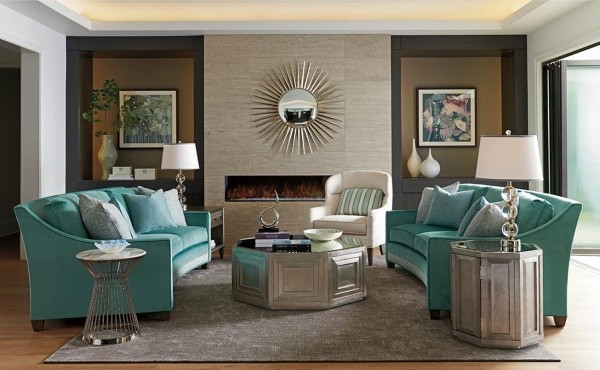luxury living room featuring two teal sofas with grey furniture, grey area rug and white chair with teal pillow