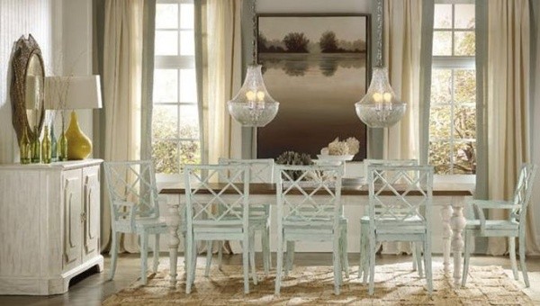 luxury dining room with white and brown table with eight white wood chairs with white cabinets