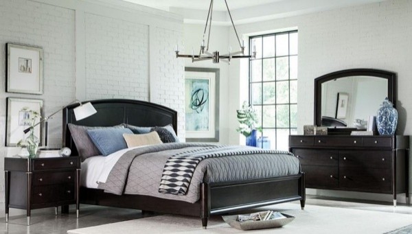 luxury home furniture master bedroom with black wood bed frame and black dresser with grey, white, and blue bedding