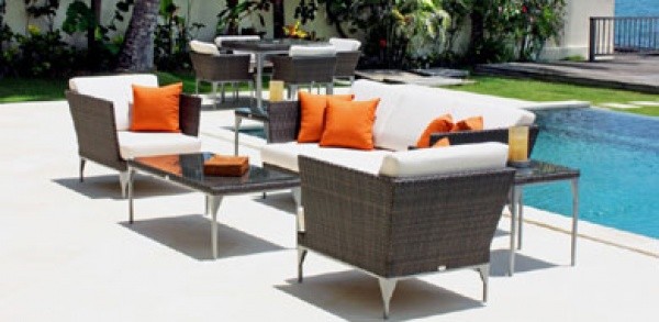 luxury patio including white and orange color scheme with white and wicker sofa and chairs with orange pillows