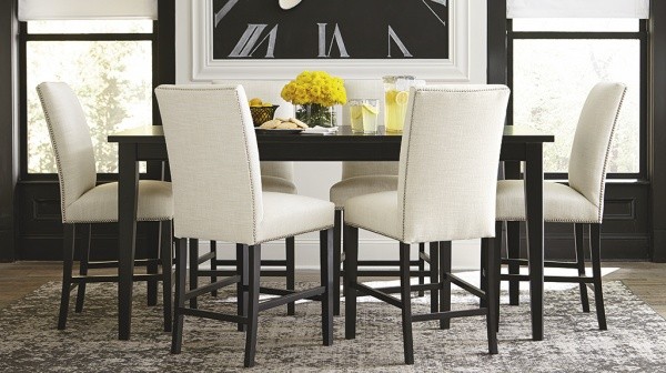 luxury dining room with black rectangle shaped table with 6 white leather and black wood chairs