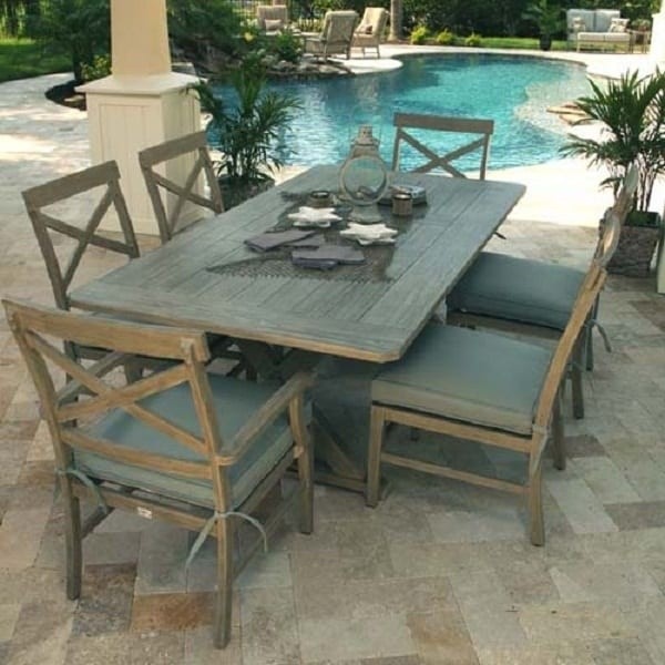 luxury patio including rectangular wooded dining table with six chairs next to a swimming pool