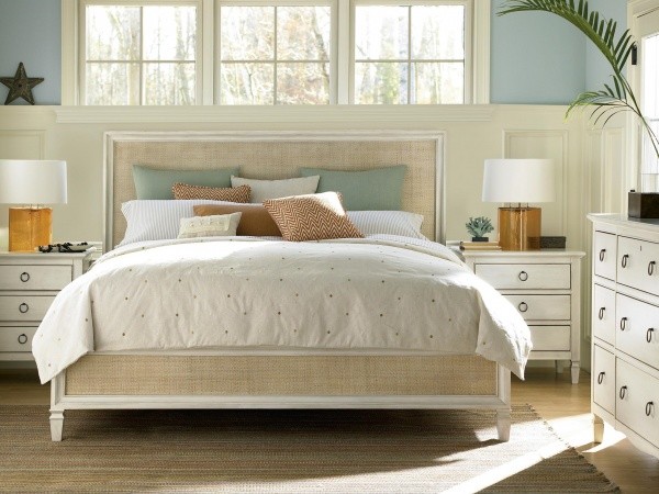 luxury home furniture master bedroom with green, cream, and brown colors, including a light brown bed frame and cream furniture