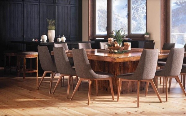 luxury dining room with large wooden table with seating for twelve guests with brown wooden chairs