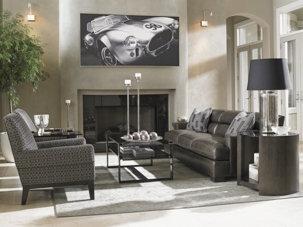 luxury living room featuring brown leather sofa with race car painting, grey chair and grey furniture
