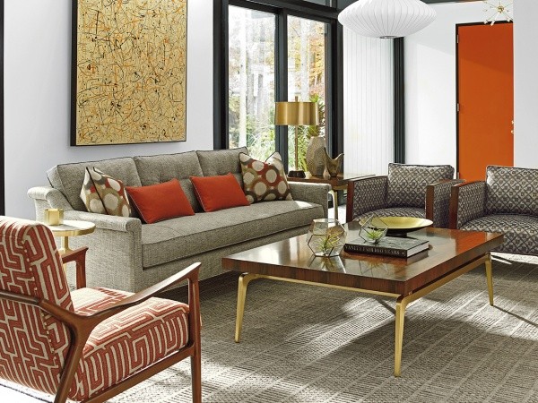 luxury living room featuring grey and orange color scheme with grey sofa with grey and orange pillows and grey and orange chairs with wood table