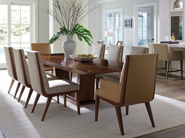 luxury dining room with dark brown wooden table with eight light brown and wood chairs
