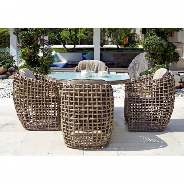 luxury patio including a round glass top table and four large brown wicker chairs