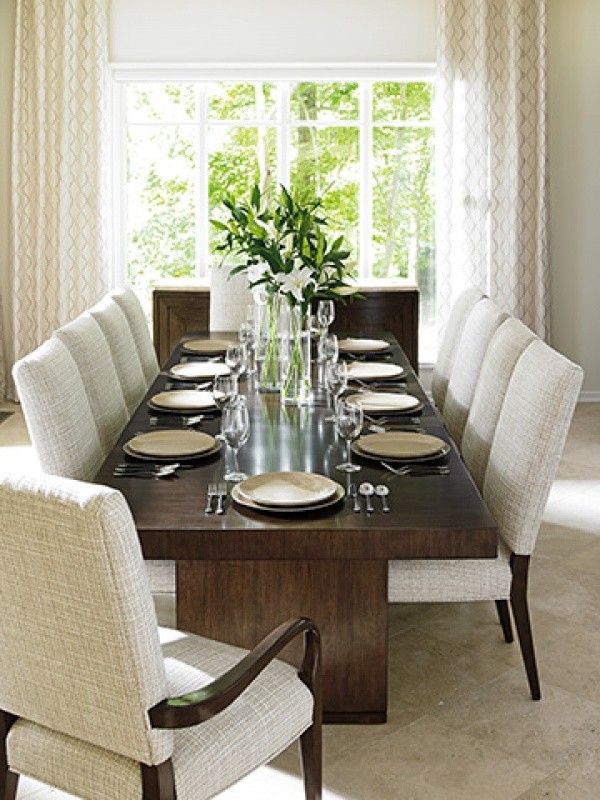 luxury dining room with wooden table with ten white and wood chairs
