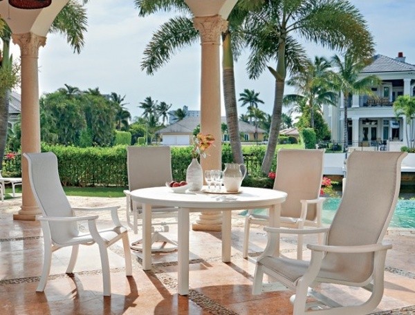 luxury patio including all white round table and 4 white wooden chairs