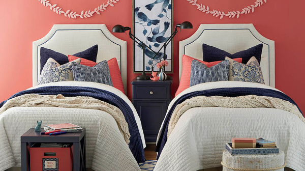 luxury finished interior bedroom with two beds featuring a red, white, and blue color scheme and blue wooden furniture